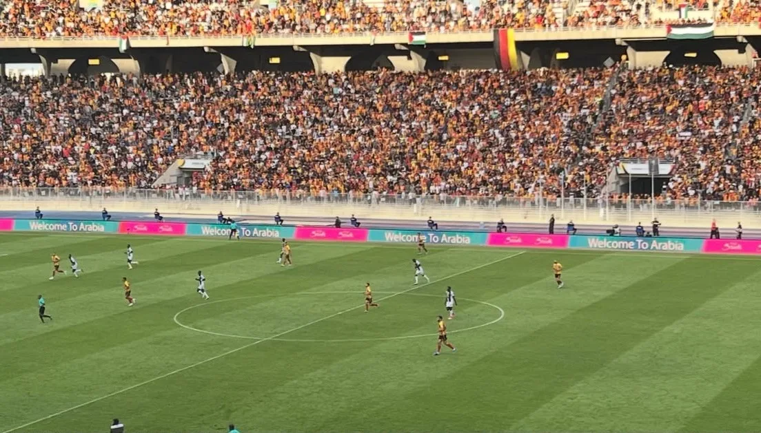Espérance Sportive de Tunis match at the Radès stadium, with packed stands and perimeter LED boards along the pitch
